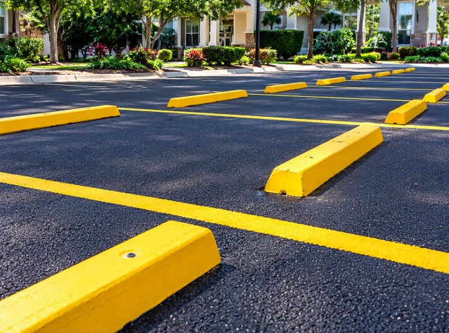 Commercial parking lot with leveled access areas and yellow parking blocks